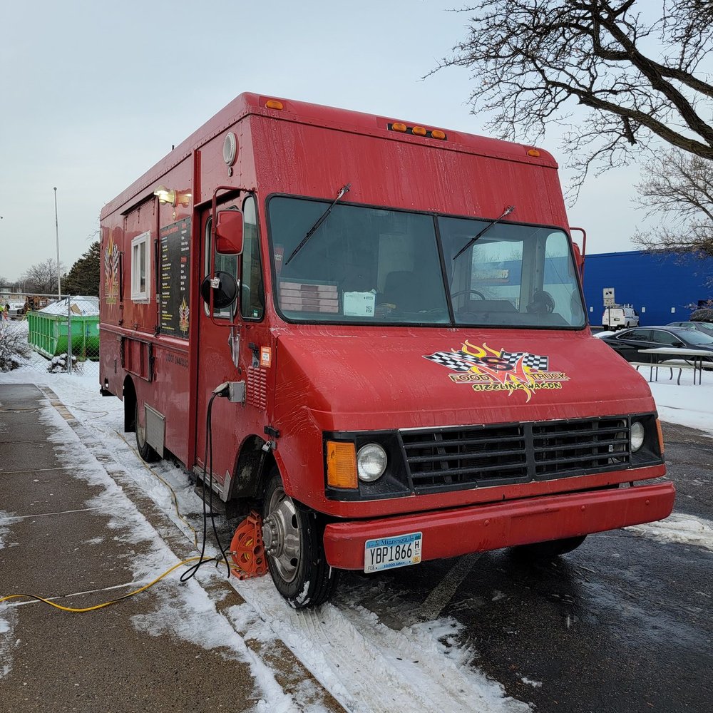 Sizzling Wagon - a red food truck parked in a parking lot - Food Trucks Near Me Sizzling Wagon - a red food truck parked in a parking lot - Food Trucks Near Me