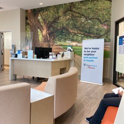 Village Medical at Walgreens - Reception Desk and Houston Park wall photo.