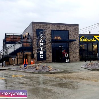 Crafted Coffee Brews - Beautiful new place - A contemporary commercial building features brick and dark panel exterior with signage for 'URBAN' and 'Pokeworks,' situated in a parking lot on a cloudy day. - Coffee & Tea Near Me - Bloomington, Illinois