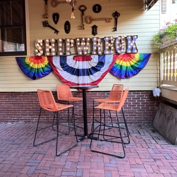 Shipwreck Lounge - a table and chairs on a brick patio - Wine Bars Near Me - Provincetown, Massachusetts Shipwreck Lounge - a table and chairs on a brick patio - Wine Bars Near Me - Provincetown, Massachusetts