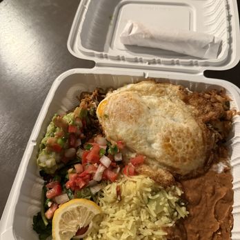 Tumerico - Machaca Plate to go - A takeout box contains rice, fried eggs, guacamole with pico de gallo, and refried beans, representing Mexican cuisine. - Vegan Near Me - Tucson, Arizona