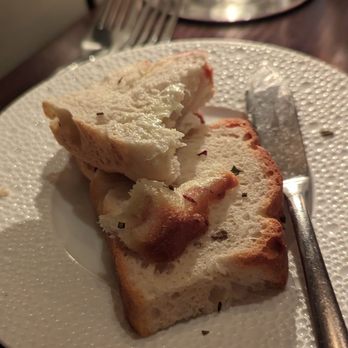 Deuxave - Bread portion (half eaten) this is one portion for $3 - New American Near Me - Boston, Massachusetts Deuxave - Bread portion (half eaten) this is one portion for $3 - New American Near Me - Boston, Massachusetts