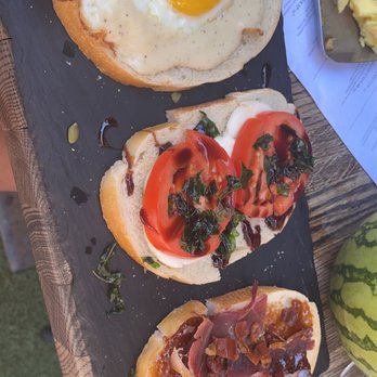 The Lola - 3 Toasts Brunch. EGGS & BACON, FRESH MOZZARELLA, BASIL, TOMATO, OLIVE OIL, BALSAMIC VINEGAR and FIG & PROSCIUTTO - Cocktail Bars Near Me - Glendale, Arizona The Lola - 3 Toasts Brunch. EGGS & BACON, FRESH MOZZARELLA, BASIL, TOMATO, OLIVE OIL, BALSAMIC VINEGAR and FIG & PROSCIUTTO - Cocktail Bars Near Me - Glendale, Arizona