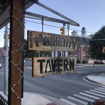 Old Mountain Tavern - a wooden sign hanging from the side of a building - Sports Bars Near Me - Marlinton, West Virginia