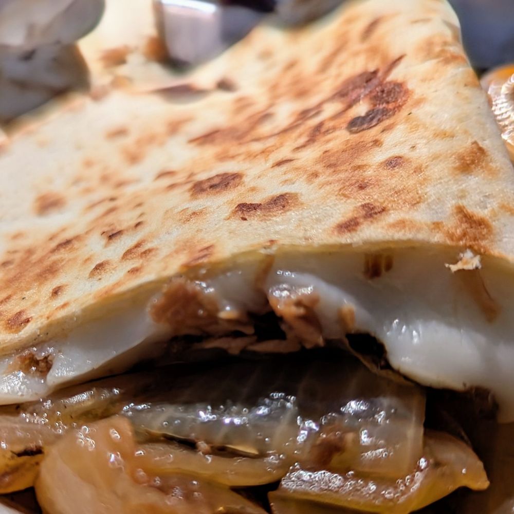 Cuantos Tacos - Close up of the Brisket Quesadilla - Mexican Near Me - Austin, Texas Cuantos Tacos - Close up of the Brisket Quesadilla - Mexican Near Me - Austin, Texas