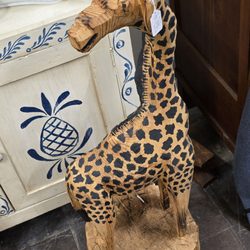 Charlotte's Web Antique Mall - A Giraffe wooden statue.