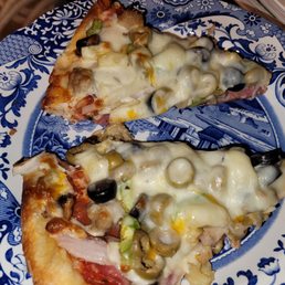 two slices of pizza on a blue and white plate