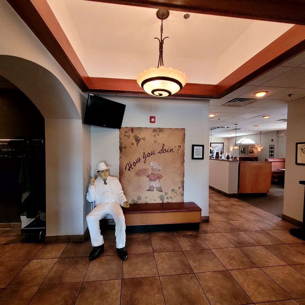 Papa Luigi's - a man sitting on a bench in a hotel lobby - Pizza Near Me - Cudahy, Wisconsin Papa Luigi's - a man sitting on a bench in a hotel lobby - Pizza Near Me - Cudahy, Wisconsin