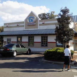 a woman walking in front of a restaurant