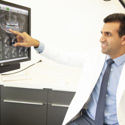 Beverly Hills Periodontist - Dr. Justin Raanan reviewing CT Scan