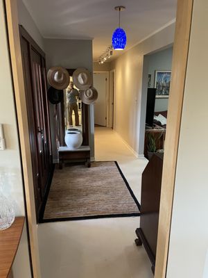 Austin water damage project. - Water damage stretched the entire length of the home. We demo'd and replaced the wood and hard surface flooring, as well as wall tile in the guest bathroom. We also installed baseboards, wall paint, and upgraded lighting.