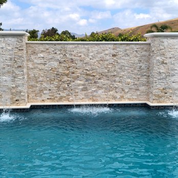 Swan Pools West - a pool with a waterfall - Landscaping Near Me