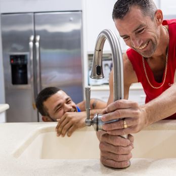 Casual Homes - a man washing his hands in a kitchen sink - General Contractors Near Me Casual Homes - a man washing his hands in a kitchen sink - General Contractors Near Me