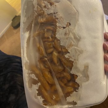 Renzi's Pizzeria - a person holding a tray of fries - Pizza Near Me - Philadelphia, Pennsylvania