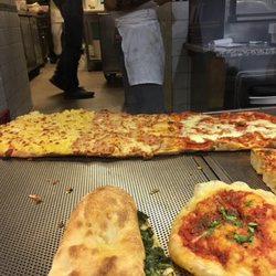 Pizza Romana dal 1995 - Cool custom paddle for the pizza and a scissors to cut it.