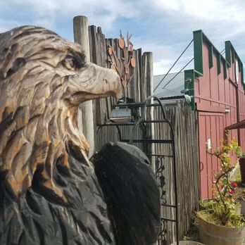 Eagle Haven Winery - Wooden eagle sitting off to the left of the patio entrance. - Wineries Near Me - Sedro Woolley, Washington