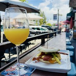 Mimosa & breakfast sandwich on their patio