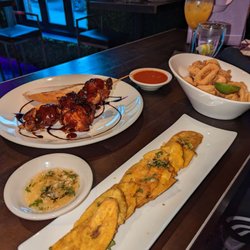 Spanglish Bar & Restaurant - Tostones with mojo sauce, BBQ chicken skewers and calamari with marinara sauce
