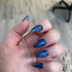 Elegant Nails - Blue gel nails with a black butterfly wing outline, complete with white dots to mimic the butterfly effect