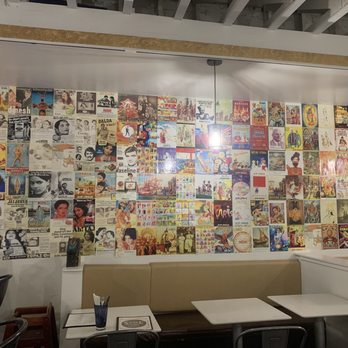 Spice Lounge - Indian pop culture art as an accent wall surrounding the eating area. - Indian Near Me - San Diego, California
