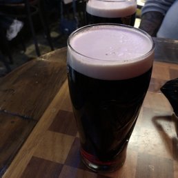two glasses of dark beer