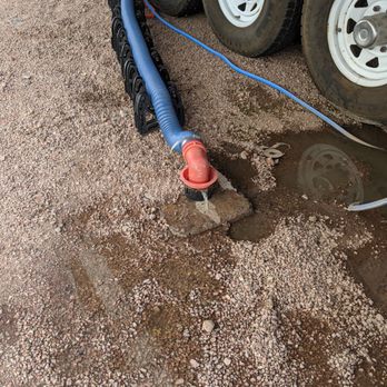 VIP RV Resort & Storage - Sewage leaking from sewer drain onto ground. Our portable water hose sits in this sewage pool - Resorts Near Me - Apache Junction, Arizona