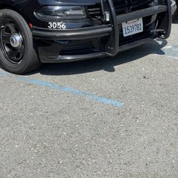 Parked in a painted handicap stall, cars next to it not even parked in a stall. Parked in a painted handicap stall, cars next to it not even parked in a stall.