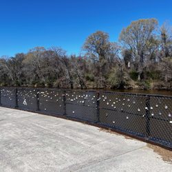 Town Common - Riverside walkway with colorful locks on the fence
