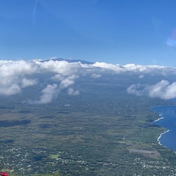 Safari Helicopters - View of Mauna Kea (above the clouds) and the coastline - Aerial Tours Near Me - Hilo, Hawaii Safari Helicopters - View of Mauna Kea (above the clouds) and the coastline - Aerial Tours Near Me - Hilo, Hawaii