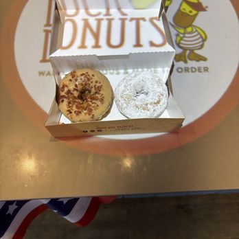 Duck Donuts - Maple Bacon donut amd a powdered donut. - Donuts Near Me - Jacksonville, Florida Duck Donuts - Maple Bacon donut amd a powdered donut. - Donuts Near Me - Jacksonville, Florida