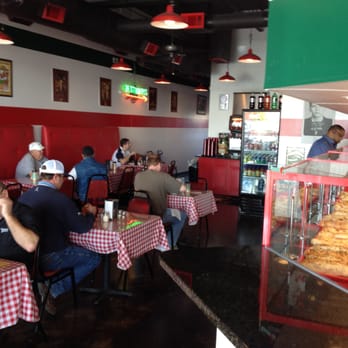 Famous Joe's - a man sitting at a table in a restaurant - Pizza Near Me - Carrollton, Texas Famous Joe's - a man sitting at a table in a restaurant - Pizza Near Me - Carrollton, Texas