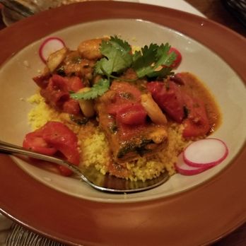 Hummus Kitchen - Moroccan fish (salmon), couscous. Tomato base sauce with sweet and spicy red peppers. Heat is cumulative but doable for sissies like me! - Middle Eastern Near Me - New York, New York Hummus Kitchen - Moroccan fish (salmon), couscous. Tomato base sauce with sweet and spicy red peppers. Heat is cumulative but doable for sissies like me! - Middle Eastern Near Me - New York, New York