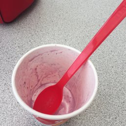 a red spoon in a cup of ice cream a red spoon in a cup of ice cream