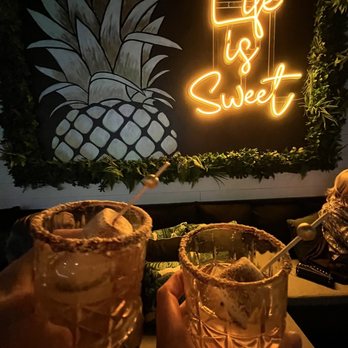 Sol Mar Cocktail Lounge - two people holding cocktail glasses - Lounges Near Me - Vero Beach, Florida Sol Mar Cocktail Lounge - two people holding cocktail glasses - Lounges Near Me - Vero Beach, Florida