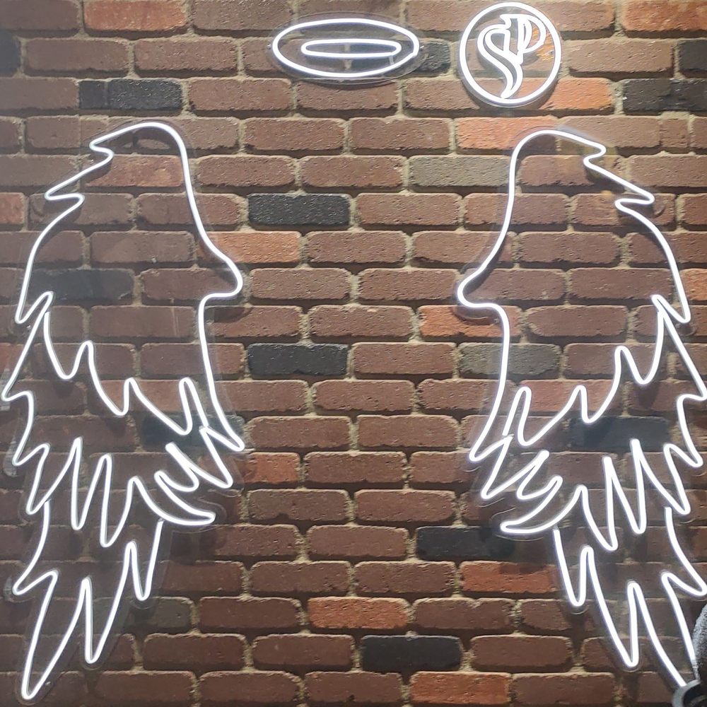 Santo Placer - Neon angel wings near the entrance - Steakhouses Near Me - San Diego, California Santo Placer - Neon angel wings near the entrance - Steakhouses Near Me - San Diego, California