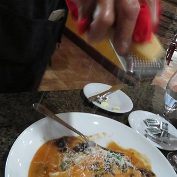 Marcelina's Italian Restaurant - Server Bob with freshly grated cheese on our main courses. - Italian Near Me - Ocala, Florida Marcelina's Italian Restaurant - Server Bob with freshly grated cheese on our main courses. - Italian Near Me - Ocala, Florida