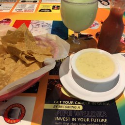a plate of chips and a drink on a table a plate of chips and a drink on a table