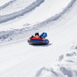 Adventure Mountain Lake Tahoe - Boy snowtubing head first