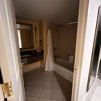 Bally's Dover Casino Resort - Spacious full bathroom with tub, toilet on the other side of door. - Casinos Near Me - Dover, Delaware Bally's Dover Casino Resort - Spacious full bathroom with tub, toilet on the other side of door. - Casinos Near Me - Dover, Delaware