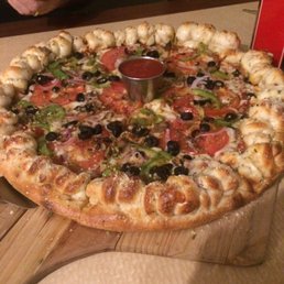 a pizza on a cutting board a pizza on a cutting board