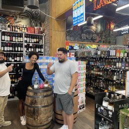 two men and a woman in a liquor store two men and a woman in a liquor store