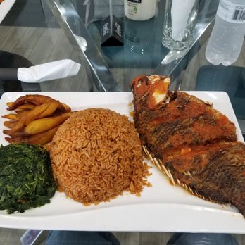 Komchop - Jollof rice with tilapia fried plantains and spinach - African Near Me - Houston, Texas Komchop - Jollof rice with tilapia fried plantains and spinach - African Near Me - Houston, Texas