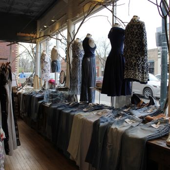 Ruby Jane  Boutique - Denver Highlands - Women's clothing, including dresses and jeans, are arranged on tables and mannequins inside a boutique with large front windows. - Women's Clothing Near Me - Denver, Colorado
