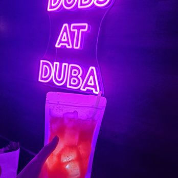 DuBa Karaoke and Pub - a person holding a drink in front of a neon sign - Karaoke Near Me - Elkins Park, Pennsylvania DuBa Karaoke and Pub - a person holding a drink in front of a neon sign - Karaoke Near Me - Elkins Park, Pennsylvania