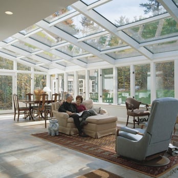 Alta Aluminum - a man and a woman sitting on a couch in a sunroom - General Contractors Near Me - Lethbridge, Alberta Alta Aluminum - a man and a woman sitting on a couch in a sunroom - General Contractors Near Me - Lethbridge, Alberta