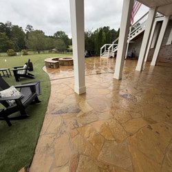 Clean Defense Force - Flagstone patio cleaning in Statham, GA -- September 24, 2026. After cleaning beside the putting green; the stone is still wet.