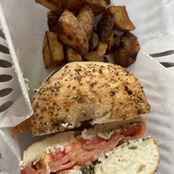 NYC Holey Moley Bagel Shop - Everything bagel with lox, cream cheese and capers. Home fries on the side.