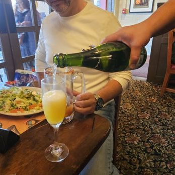 Hot Tamale Holiday UYE - Mimosas poured by our waiter Rubén. - Unofficial Yelp Events Near Me