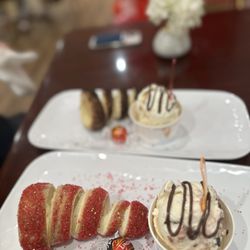 Kurly Kürtősh Café - Curly chimney cake with sparkled and cherry Amaretto ice cream And chimney cake rolled in Oreo with strawberry cheesecake ice cream