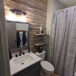 Precision Home Projects - Full bath remodel with walls, new flooring, and electrical.
